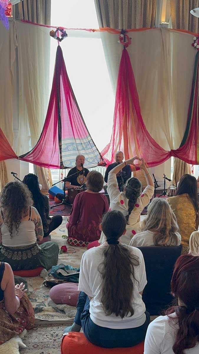 Community kirtan gathering with decorative drapes